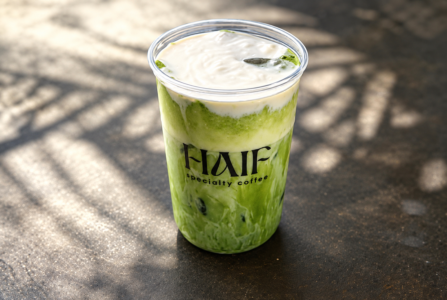 Haif iced matcha latte in its branded cup